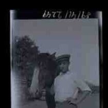 A man standing next to a horse