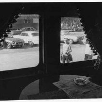 View from inside a coach looking out into a parking lot. Part of the Bicentennial celebrations