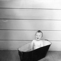 Unknown child in tub outdoors