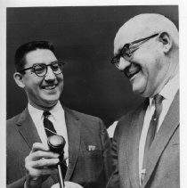 Eugene T. Gualco, left, receives the gavel from Henry Kloss. Gualdo is the new chairman of the Board of Supervisors. He succeeds Kloss