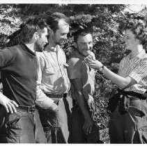 Ellen Searby, 24, fiancee of Warren Harding, who led the first team to conquer El Capitan, holds up a mirror for (from left) Harding, George Whitmore, and Wayne Merry