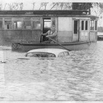 Row Boat Passes Submerged Car