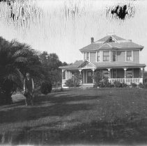 Exterior view of a man in front of the Cunningham house on Sunset Ave. near New York in Fair Oaks