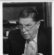 Howard Jarvis, businessman, lobbyist and anti-tax advocate behind Proposition 13, shown here seated, with a notepad