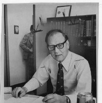 Judge Rothwell B. Mason, Municipal Court Judge, in his office, looking at paperwork