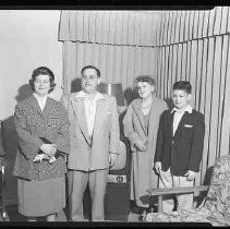 Four people sitting on a sofa