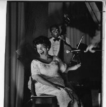 Blues singer Nellie Lutcher sitting at piano and performing