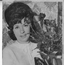 Mrs. Earl Huffman with "long distance" roses, delivered to her by Governor Reagan on behalf of her husband, serving in Viet Nam