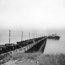 A line of cars parked on a bridge