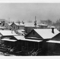 Copy Print: View of a rare snow storm in Sacramento. This view is taken from 6th and 7th Streets on E Street looking south. the county courthouse is in the background