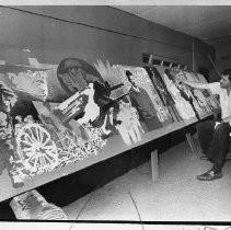 Dean Gleisberg, artist and employee of Sacramento Army Depot. He is shown with his 40-foot mural created for the Bicentennial