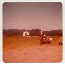 Photographs of landscape of Bolinas Bay. Backhoe with archaeologist working