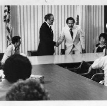 Benjamin Hooks, the American Civil Rights leader, is greeted by Lt. Gov. Mervyn Dymally and legislators at an NAACP meeting. Hooks, a minister and attorney, served as the executive director of the NAACP from 1977-1992