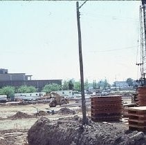 Site of the Downtown Plaza Parking Garage, Lot "G" near Macy's Department Store, 4th, 5th K and L Streets under construction. This view is looking east from the Fratt Building in Old Sacramento