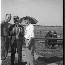 Three men with trophy