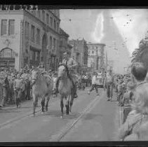 A man and a girl on horseback in a parade