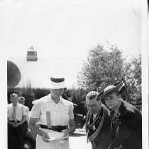 View of the N.S.G.W. and N.D.G.W. , the fraternal organizations at the Memorial Grove on the State Fair Grounds during the ceremony for planting 58 oak trees on the grounds. The three people in this view are not identified