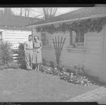 A couple in front of their cottage