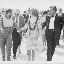 Dr. Alvin Marks, pilot and owner of Skymark Airlines. Here, walking in front of a large crowd after the flight, holding hands with his wife, Phoebe