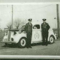 Two policemen with Accident Investigation vehicle