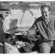 Bob Lunn, pro golfer, showing his first paycheck to Haggin Oaks pro tom LoPresti, his former boss