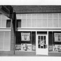 Exterior view of the Old Home Bakers company makers of Old Home and Betsy Ross Bread with a window display showing the Freer Trophy