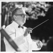 Norman Hunt, conducting an orchestra. He was a composer, conductor and arranger who chaired the Music Department at CSUS