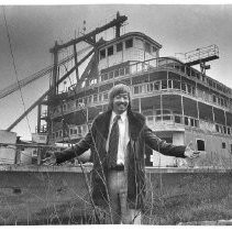 Tom Fat standing in front of the Delta King after submitting high bid at auction