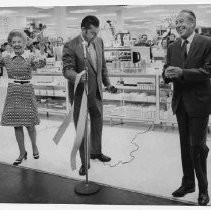 Unidentified woman and two unidentified men conducting ribbon-cutting ceremony at J. C. Penney store