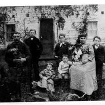 Ide home with unidentified family members posing in front