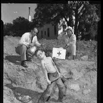 Boy and men in an excavated hole