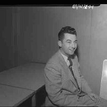 A portrait of a young man in checked sports coat