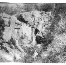 Rock formation and cave with picnickners