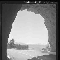 A road going through a cut in rock