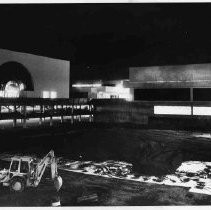 Weinstock's and parking garages under construction in this night view