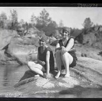 Two women sitting on a rock