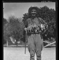 Man with dead game birds