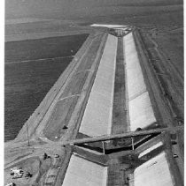 Caption reads: "From near Los Banos, a crew is shown at work lining with concrete a 103 mile stretch of the California Aqueduct between San Luis Dam and the tiny Kings County town of Kettleman City