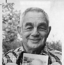 L.E. Harbert, a retired carpenter, holding a photo from a former Capitol renovation project as the current restoration project continues