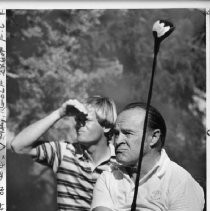 Bob Hope, the legendary comedian and movie and TV star, playing golf at Del Paso Country Club in Sacramento, with pro golfer Johnny Miller next to him