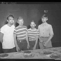 Four boys eating pie