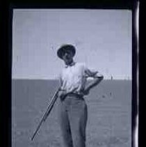 An undentified man holding a shotgun