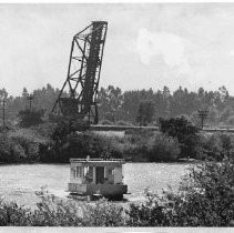 Houseboat going upstream on Georgiana Slough with railroad bridge at Isleton in background