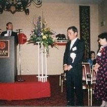 Banquet Reception: Unidentified Speaker at Podium with Woman and Man