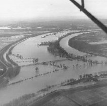 View looking east across the Sacramento River toward the mouth of the American River. North Sacramento in background. "1938 Flood"