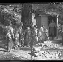 People waiting to use an outhouse toilet