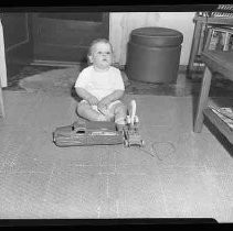 A baby playing on a floor