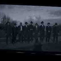 Nine young men standing in a park