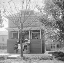 Family on front porch of home