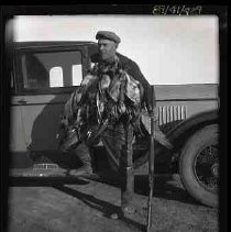 Man with dead geese